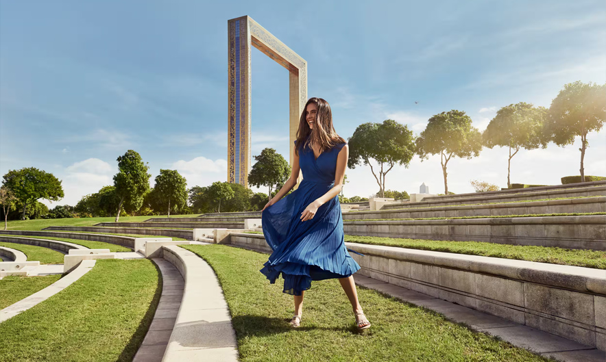 Visitors walking on glass floor inside Dubai Frame