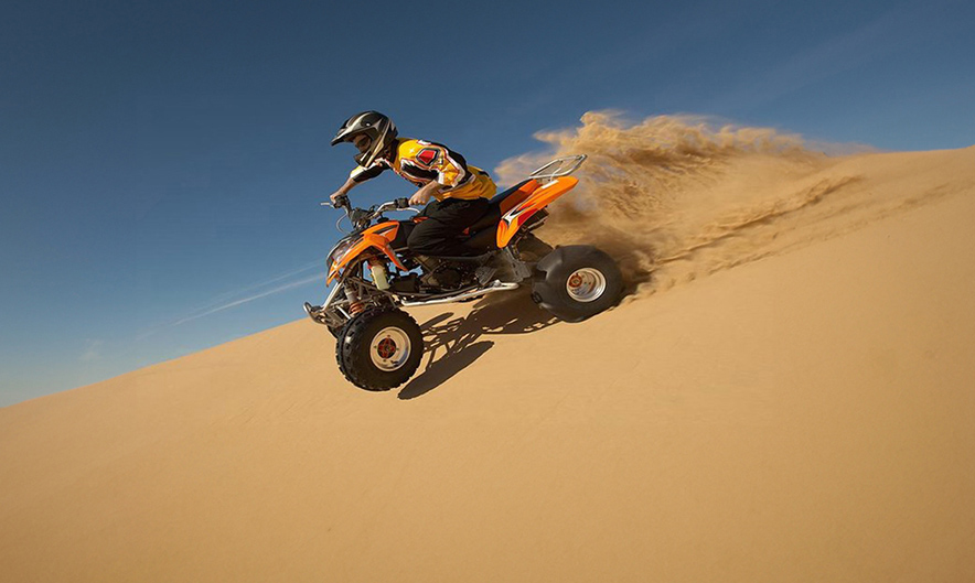 Quad bike tracks in the sand at Dubai desert